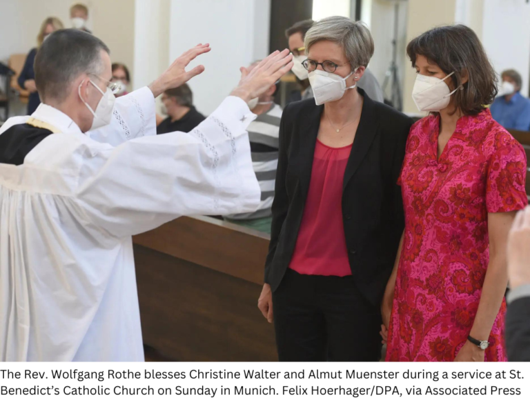The Rev. Wolfgang Rothe blesses Christine Walter and Almut Muenster during a service at St. Benedict’s Catholic Church on Sunday in Munich.